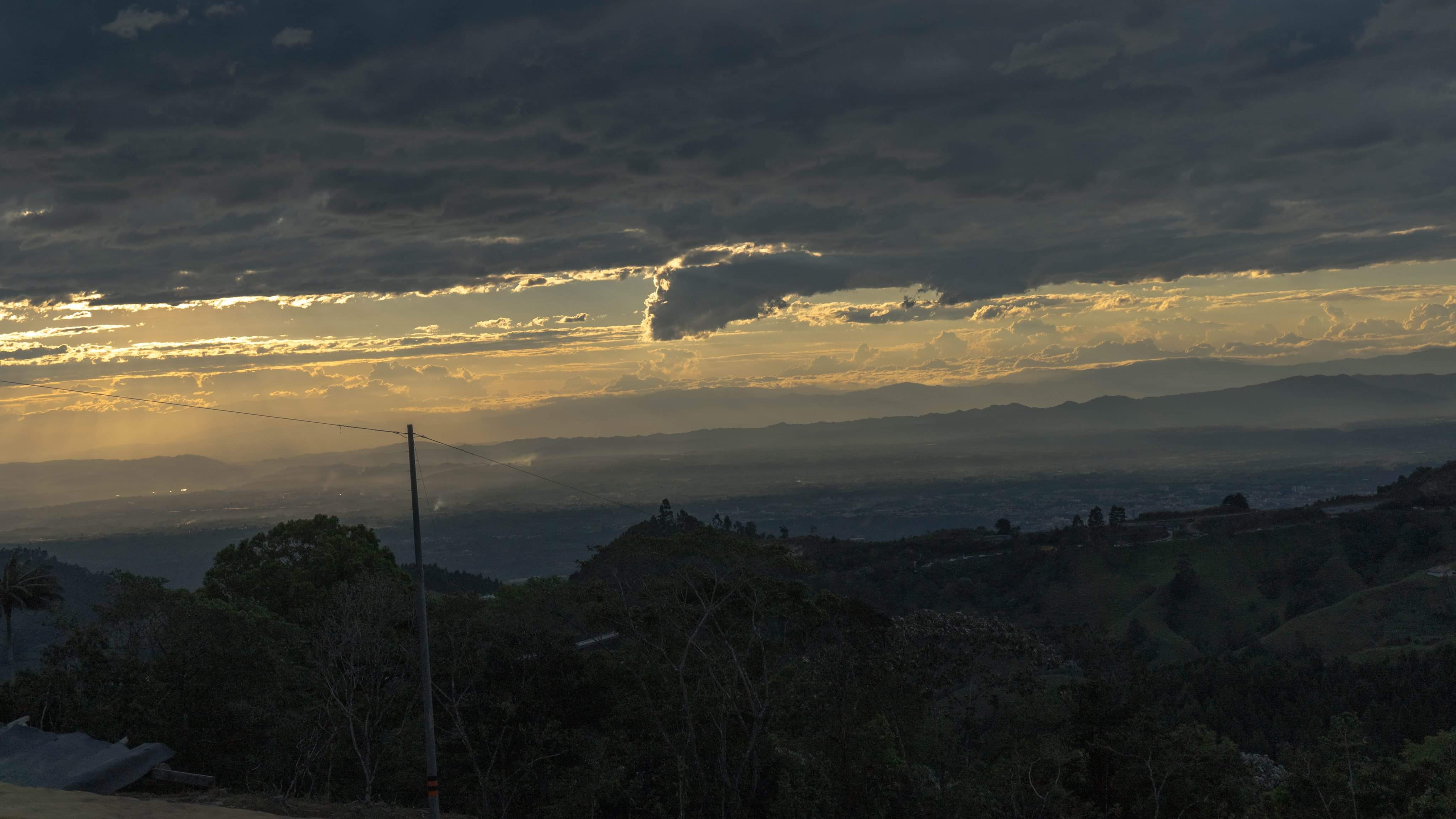 Clouds drift over layered mountain silhouettes.